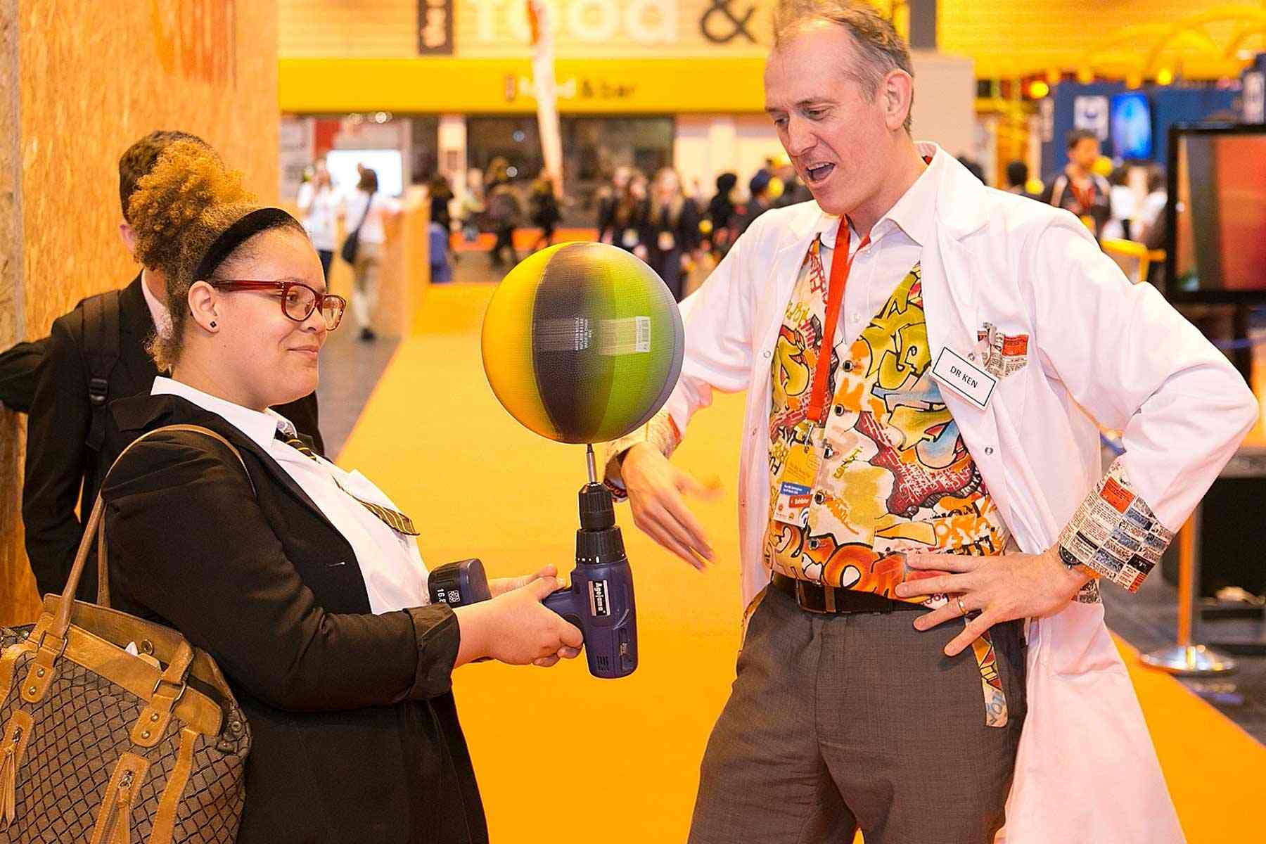 Science Busking at the Big Bang Fair Student balances a spinning basket ball on a rotating drill.