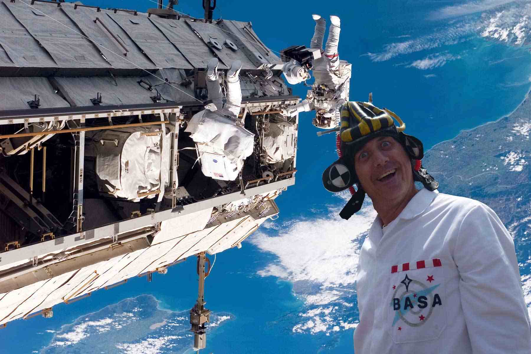 Which way is UP? Dr Ken dressed as a BASA scientist - strange lab coat and hat - pictured by the International Space Station.
